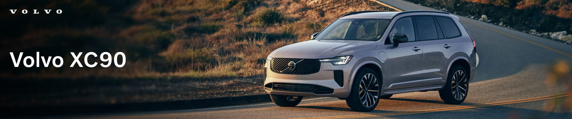 Volvo XC90 driving on a winding road with Volvo branding and model name displayed on the left.