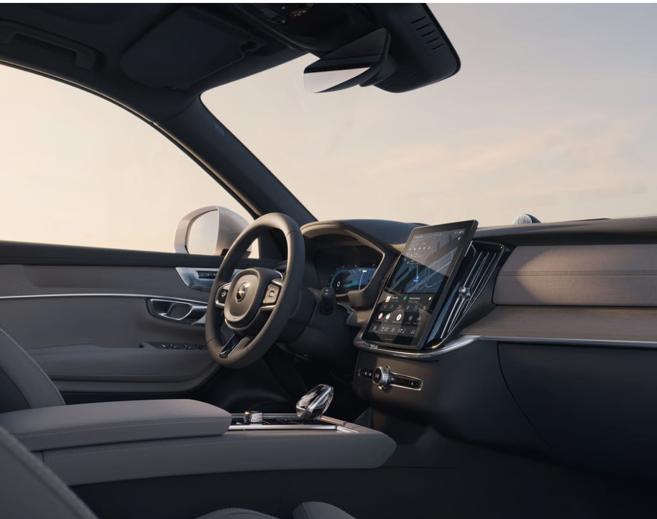 Volvo XC90 interior featuring a digital instrument cluster, large vertical center touchscreen, steering wheel, and premium cabin materials.