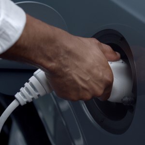 Man charging Volvo electric car