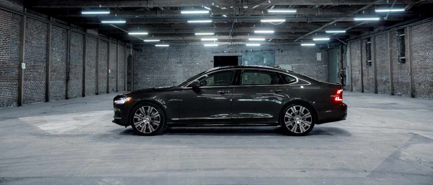 Black 2021 Volvo S90 parked inside a garage side exterior view