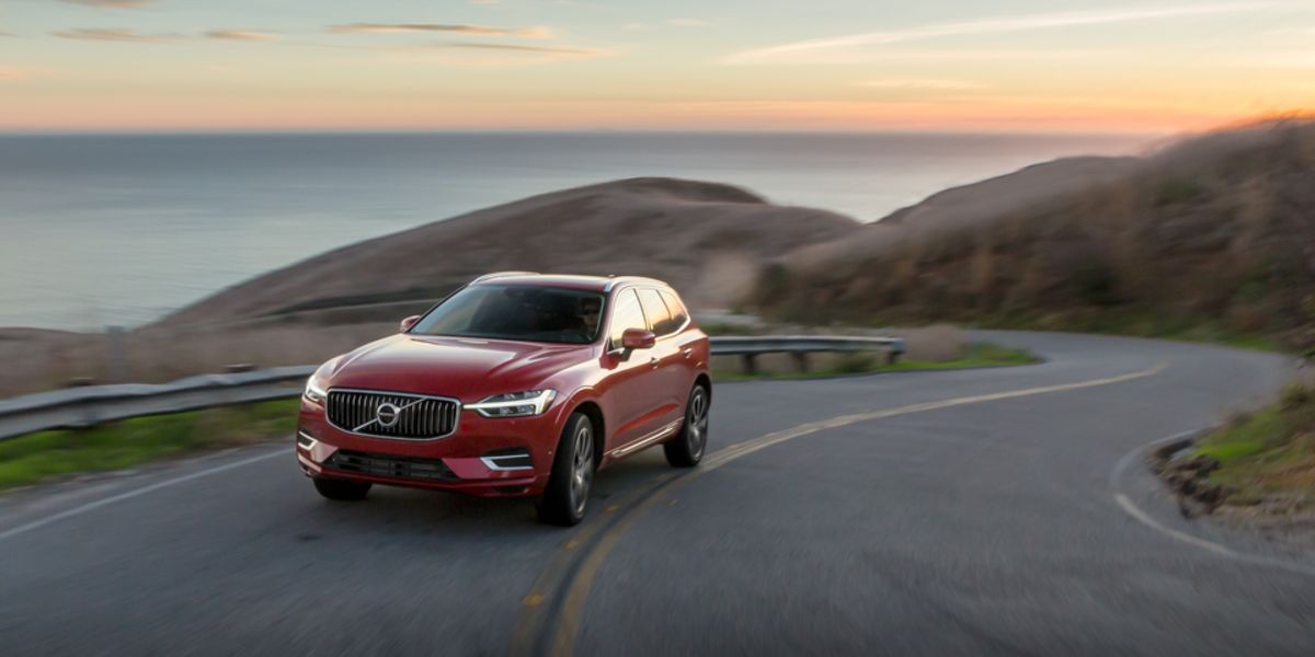 2021 Volvo XC60 Recharge T8 SUV red on winding road with body of water in background_res.jpeg