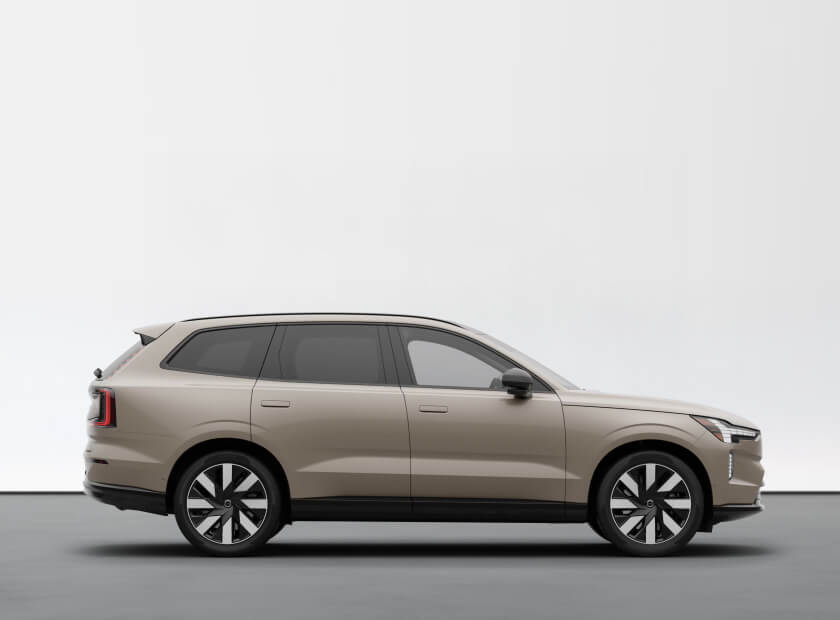 2026 Volvo EX90 Ultra in Sand Dune, side profile in a minimalist studio.