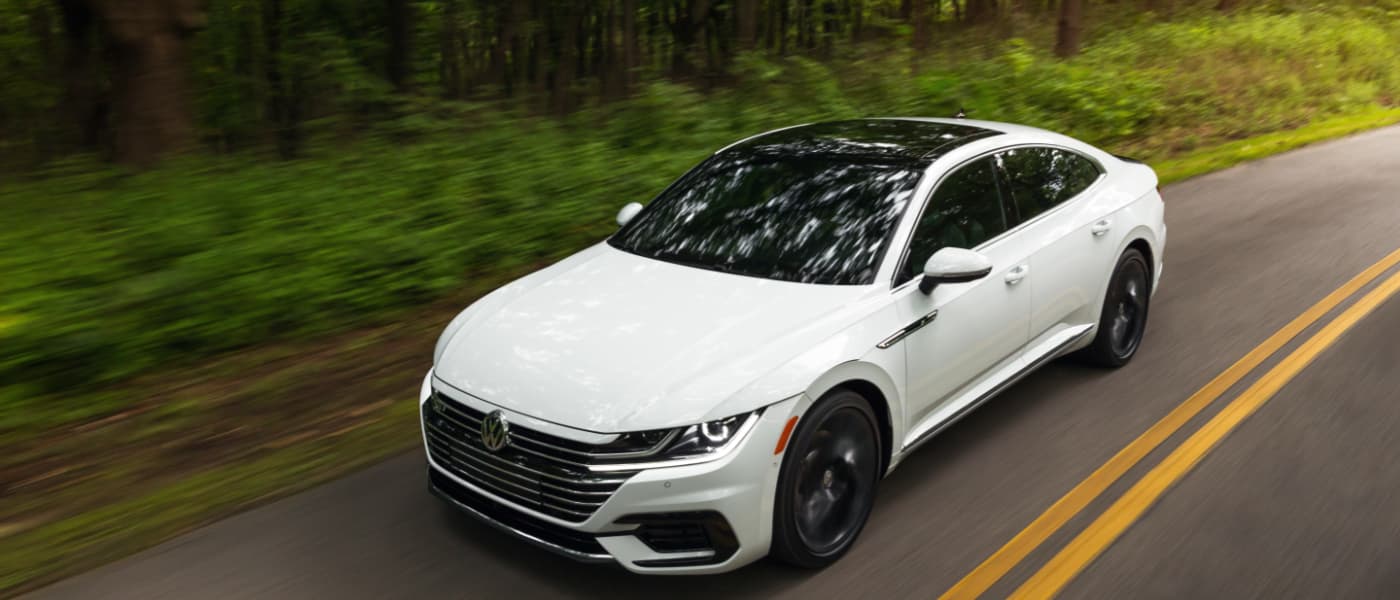 2019 White VW Arteon Driving Through Woods