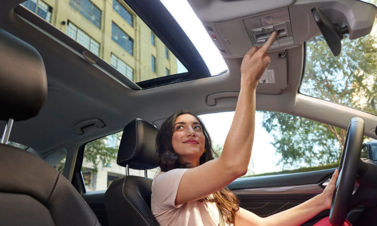 2023 Volkswagen Jetta interior woman opens sunroof
