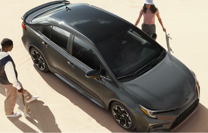 Friends getting into a grey toyota sedan