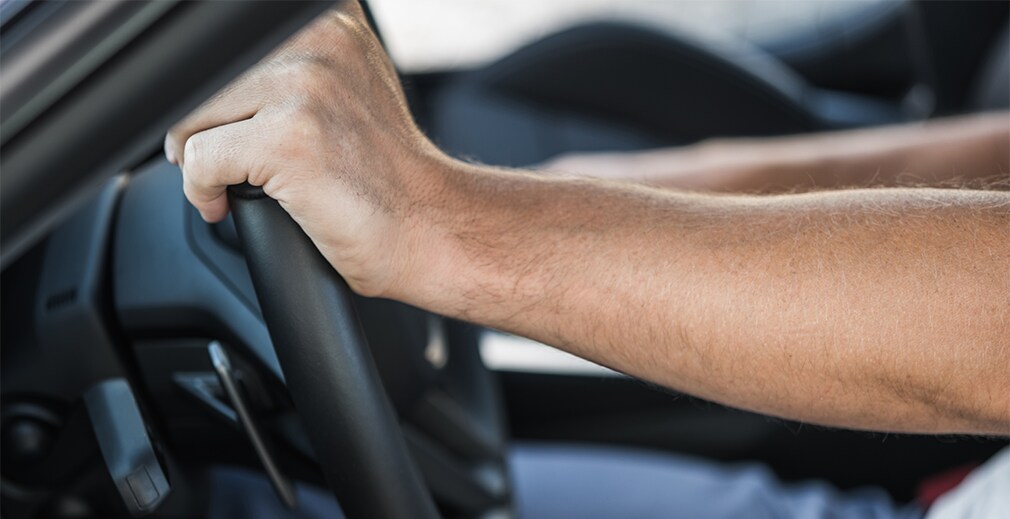 Learn Maintenance Warning Signs at West Broad Hyundai in Henrico, VA | Person's hand on the steering wheel
