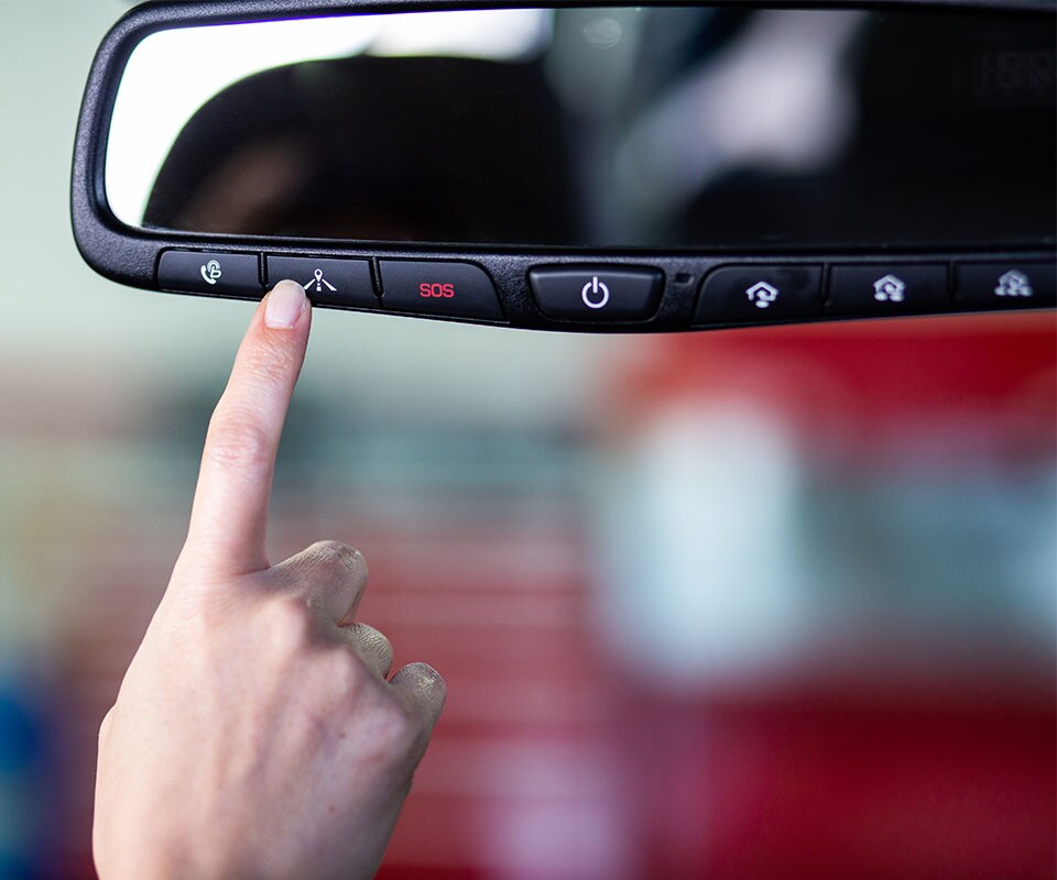 Tips for spring cleaning your car at West Broad Hyundai in Henrico, VA | Close up of Finger Pressing Rear View Mirror Controls