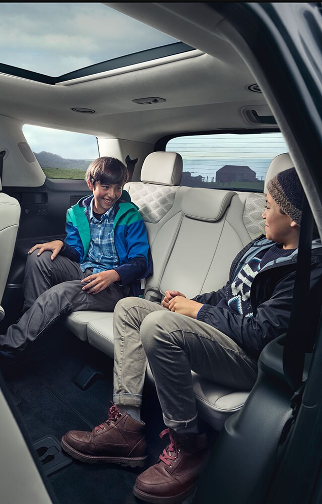 Accessories that help keep your Hyundai protected at West Broad Hyundai in Henrico, VA | Hyundai Palisade Calligraphy Interior with Children Sitting in Back Seat Talking to Each Other