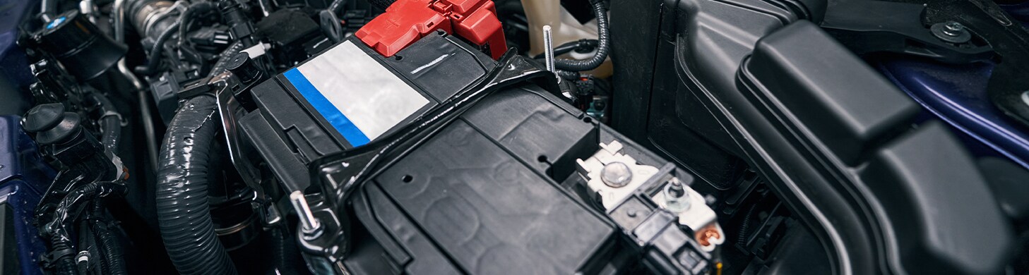 How to Get Your Car Summer Ready at West Broad Hyundai in Henrico, VA | Upclose photo of car battery in the middle of engine bay