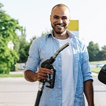 Best Gas Type for My Vehicle at West Broad Hyundai | Happy customer holds up gas nozzle