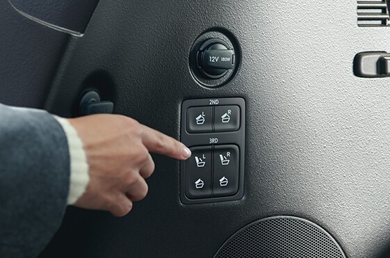 Compare the 2021 Hyundai Palisade vs. the 2021 Toyota Highlander at West Broad Hyundai | Person in suit pushing buttons for seat options