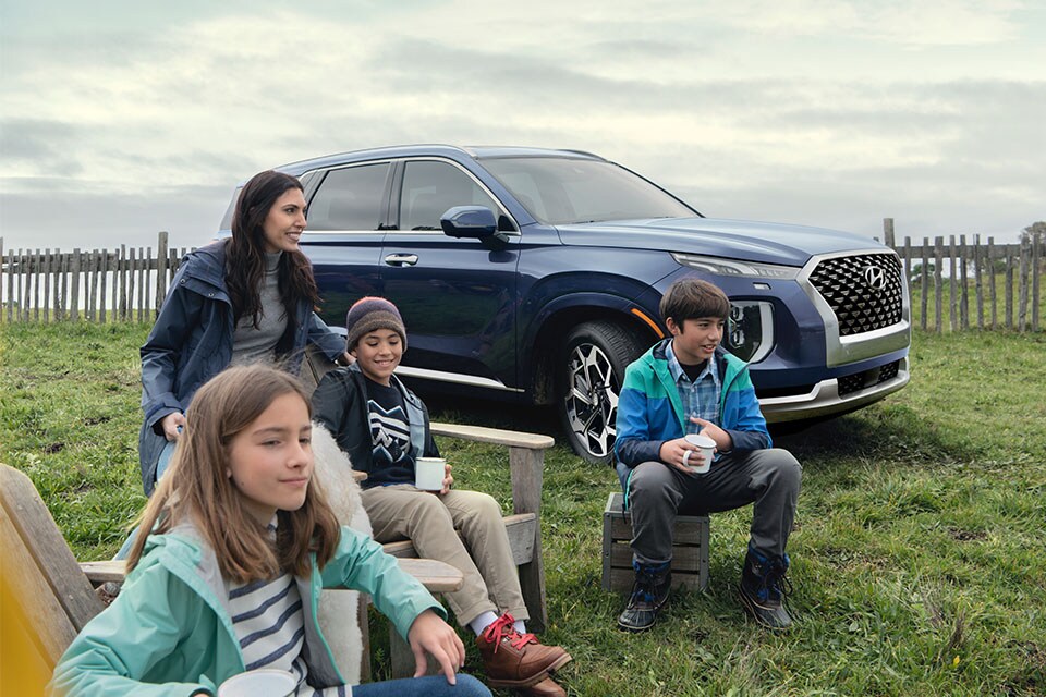 Accessories that help keep your Hyundai protected at West Broad Hyundai in Henrico, VA | Family Sitting on Chairs Next to Parked Hyundai Palisade Calligraphy at Ocean Cliff loking at Ocean