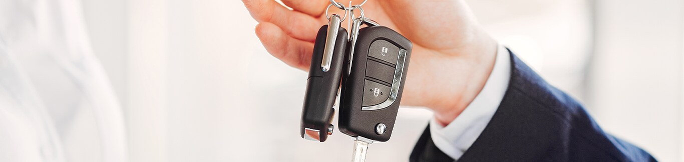 Best Time To Buy At West Broad Hyundai in Henrico, VA | Man in suit is handing over new car keys to another person