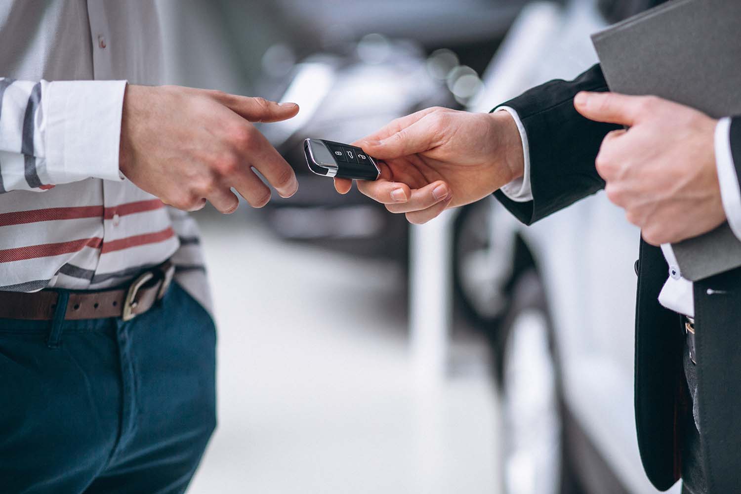 High Cost of Replacing a Car Key | West Broad Hyundai | Sales associate handing new keys to customer