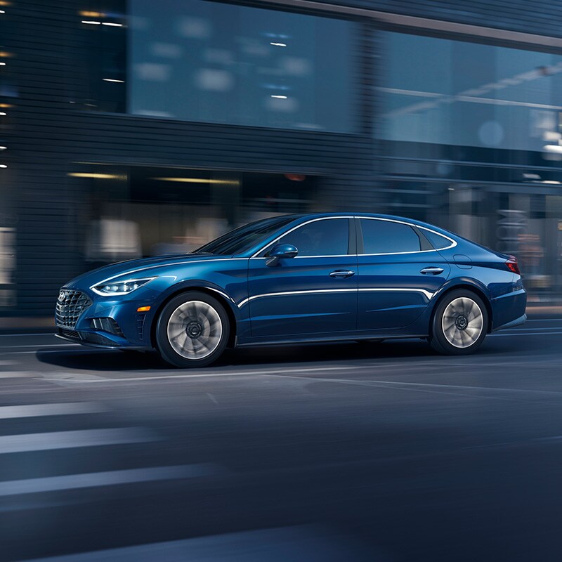 what different tire options are available at West Broad Hyundai in Richmond | Blue 2021 Hyundai Sonata Driving Fast Through City at Night