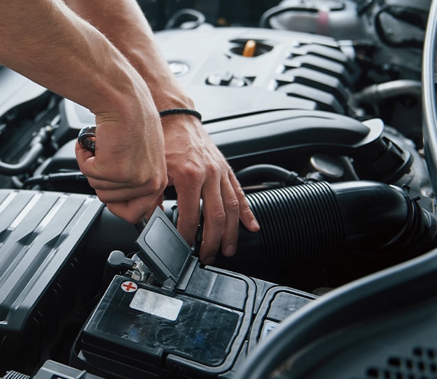 Everything You Need to Know about Your Car Battery at West Broad Hyundai | Person lifting up battery terminal cover