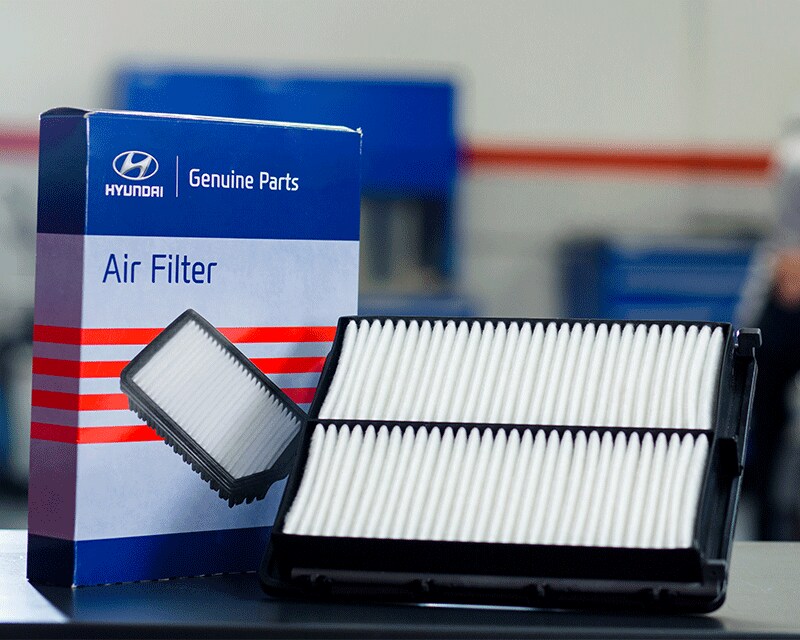 3 Main Benefits of Using OEM parts for your vehicle at West Broad Hyundai in Henrico, VA | Hyundai Genuine Accessories Air Filter Box with Air Filter Propped Against it Sitting on Table