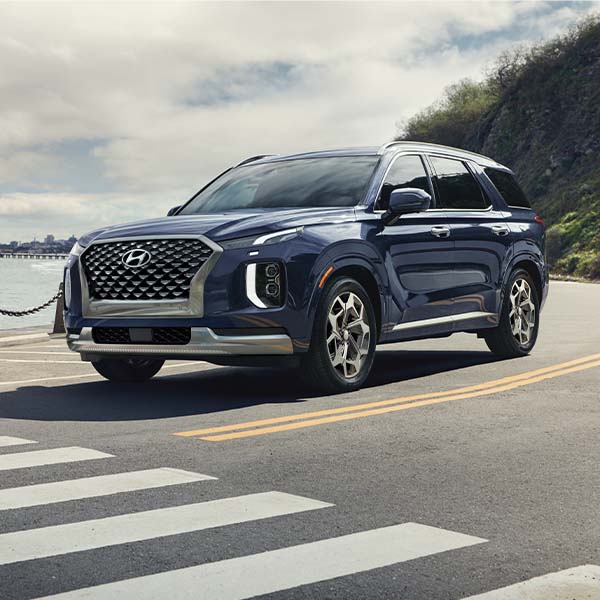 Model Features of the 2022 Hyundai Palisade at West Broad Hyundai | Blue 2022 Hyundai Palisade Stopped at Crosswalk