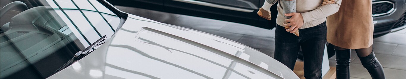 Enjoy A Test Drive At West Broad Hyundai in Henrico, VA | Couple and their child looking at the exterior of a grey car