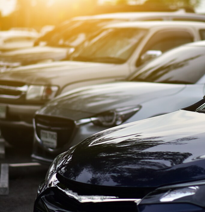 When to Trade In Your Car | West Broad Hyundai in Henrico, VA | Parking lot of different cars with a blue sedan, grey sedan, and silver SUV