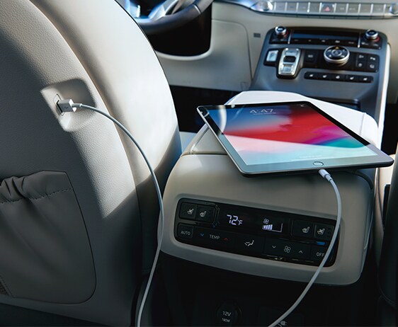 Compare the 2021 Hyundai Palisade vs. the 2021 Toyota Highlander at West Broad Hyundai | Charging tablet from drivers back seat