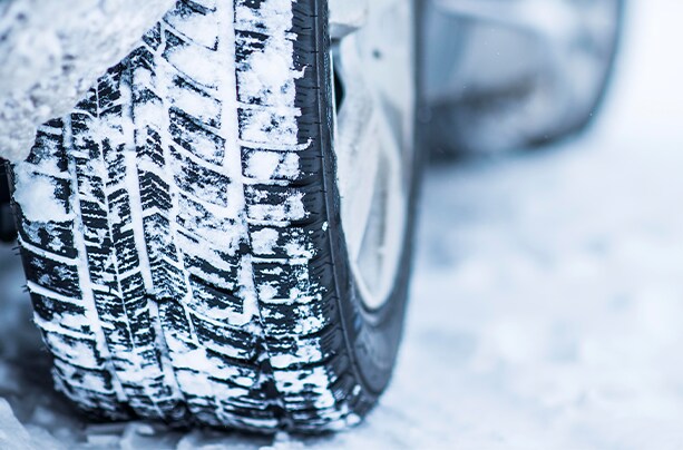 How to prepare your Hyundai for the winter season in Henrico, VA at West Broad Hyundai | Close up of car tire with snow on it and on the ground