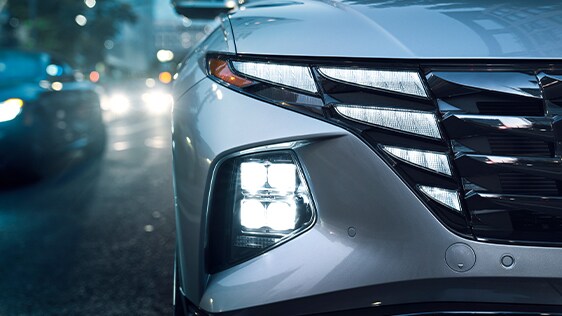 Compare the 2022 Hyundai Tucson vs. the 2021 Honda CR-V at West Broad Hyundai | Showing off front lights in bad weather