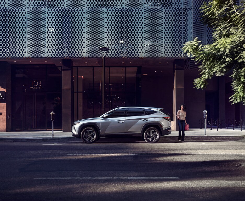 Personalize My Vehicle in Henrico, VA | Side profile of a grey 2023 Hyundai Tucson with a woman about to cross the street