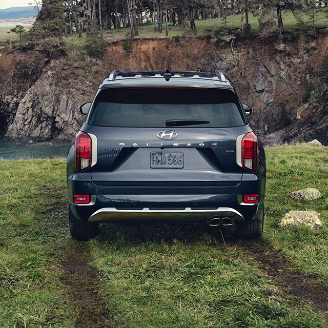 Accessories that help keep your Hyundai protected at West Broad Hyundai in Henrico, VA | Rear View of Hyundai Palisade Calligraphy Parked in front of Ocean Cliffs