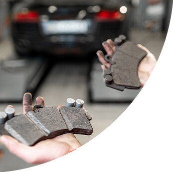 Brake replacement and Safety at West Broad Hyundai | Hyundai mechanic holds out two brake pads
