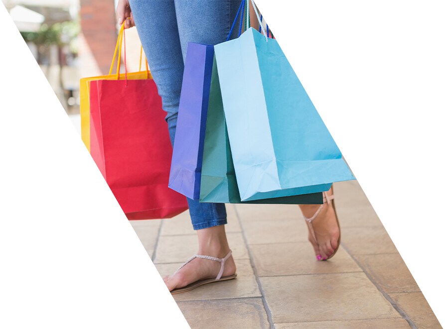 West Broad Hyundai is a Hyundai Dealership in Richmond near Short Pump, VA | Woman Walking Outside Carrying Shopping Bags