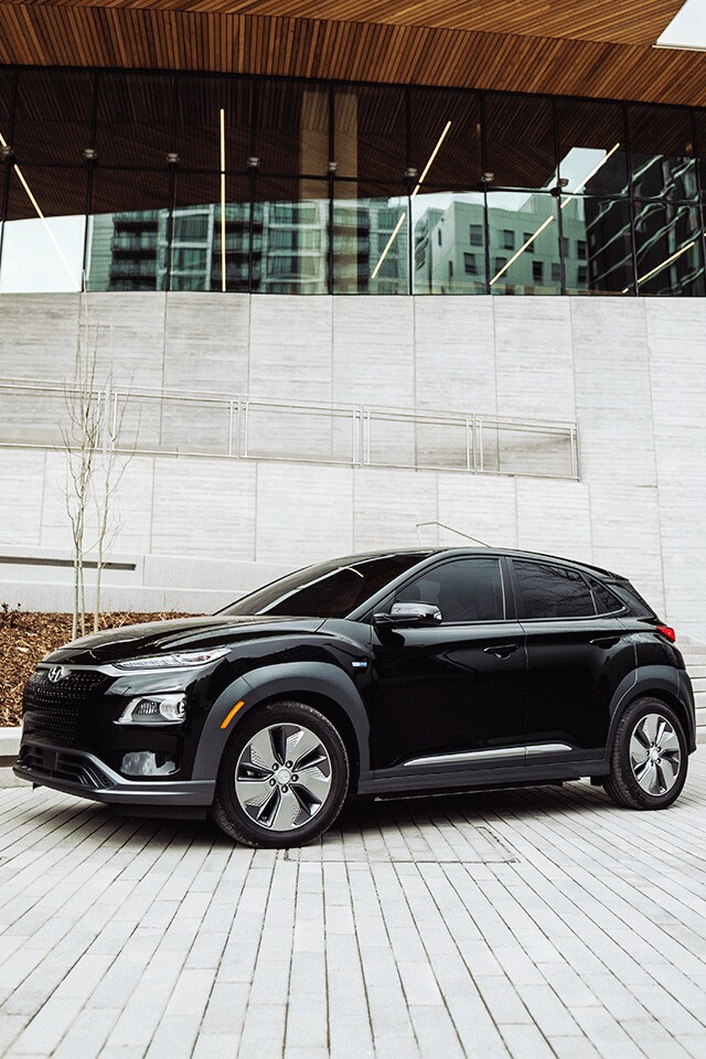 Things to Check When Buying a Used Car | West Broad Hyundai in Henrico, VA | 2021 Hyundai Kona EV Ultimate Facing Left Parked in Front of Glass Building
