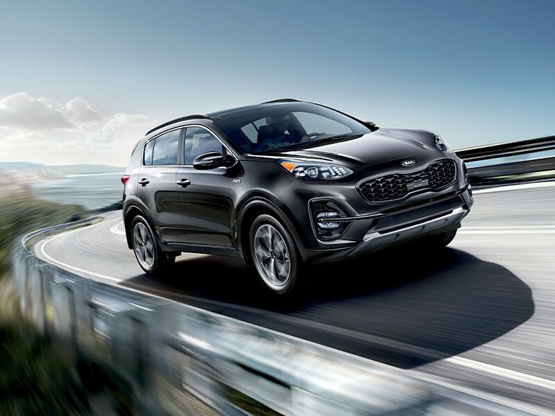 what different tire options are available at West Broad Kia in Richmond | Black 2021 Kia Sportage Driving Around Bend Fast