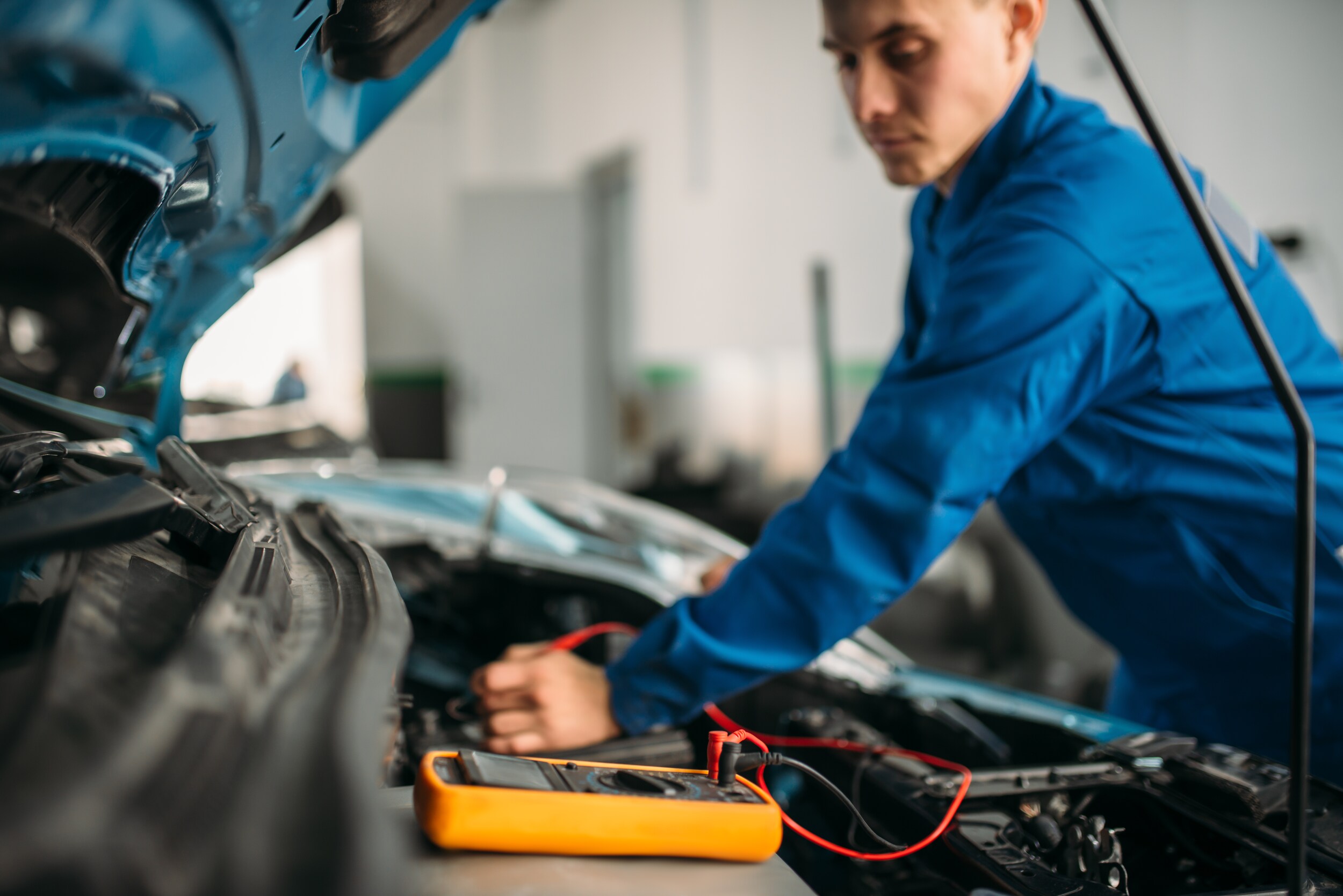 West Broad Kia is a Kia Dealership in Richmond near Laurel, VA | Mechanic working under the hood of Kia vehicle