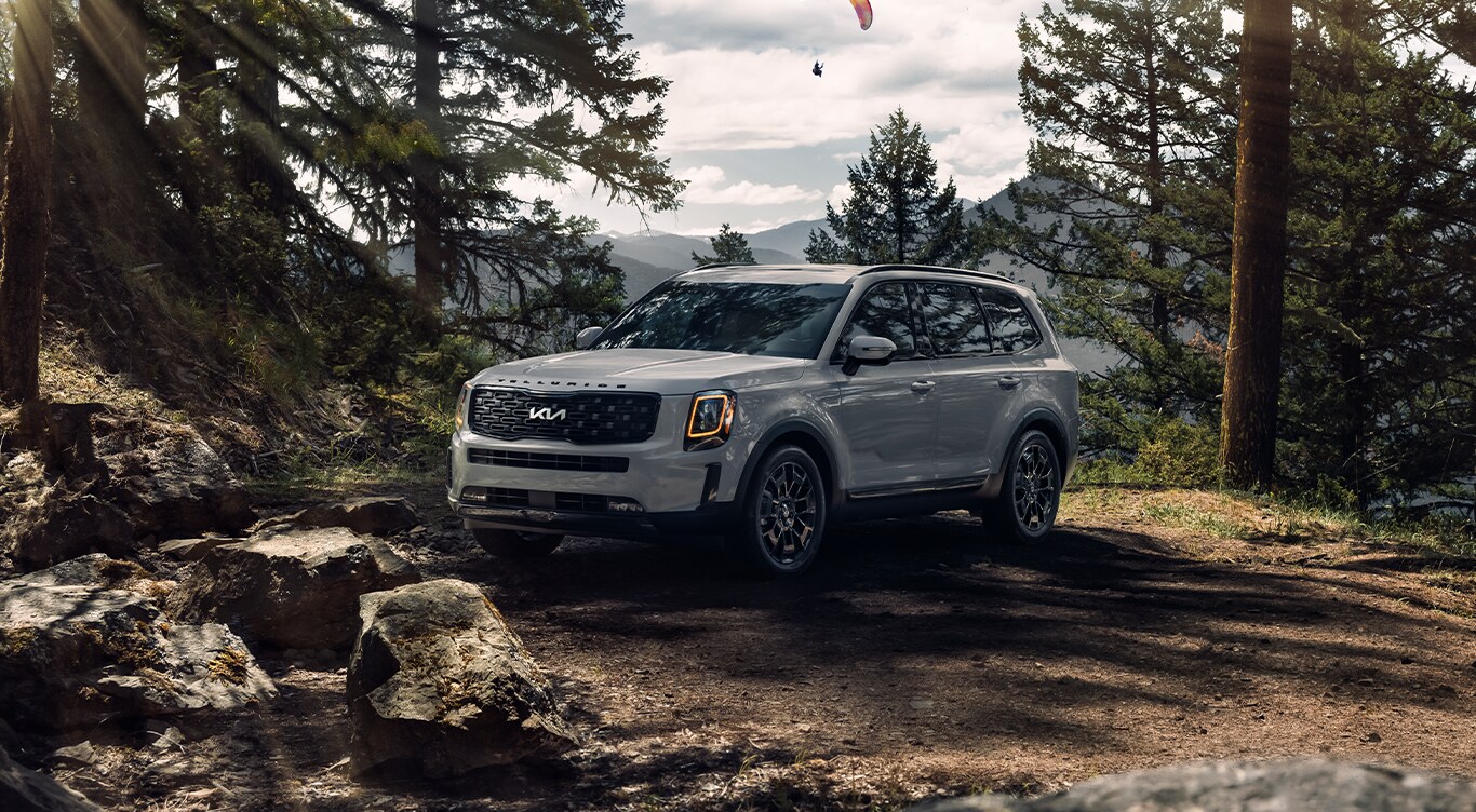 Android Auto vs. Apple CarPlay at West Broad Kia in Henrico, VA | Grey 2023 Kia Telluride parked in the middle of the woods