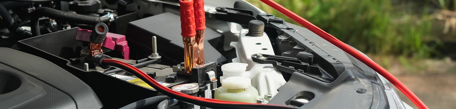 How to Jump Start a Car | West Broad Kia in Henrico, VA | Battery jumper cables connected to car battery