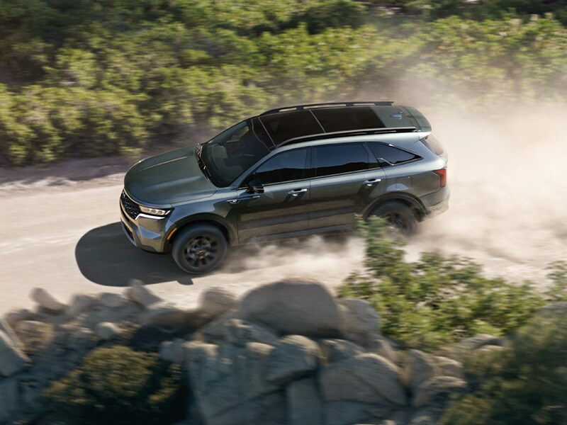 what different tire options are available at West Broad Kia in Richmond | Aerial View of 2022 Kia Sorento Driving on Dusty Dirt Road