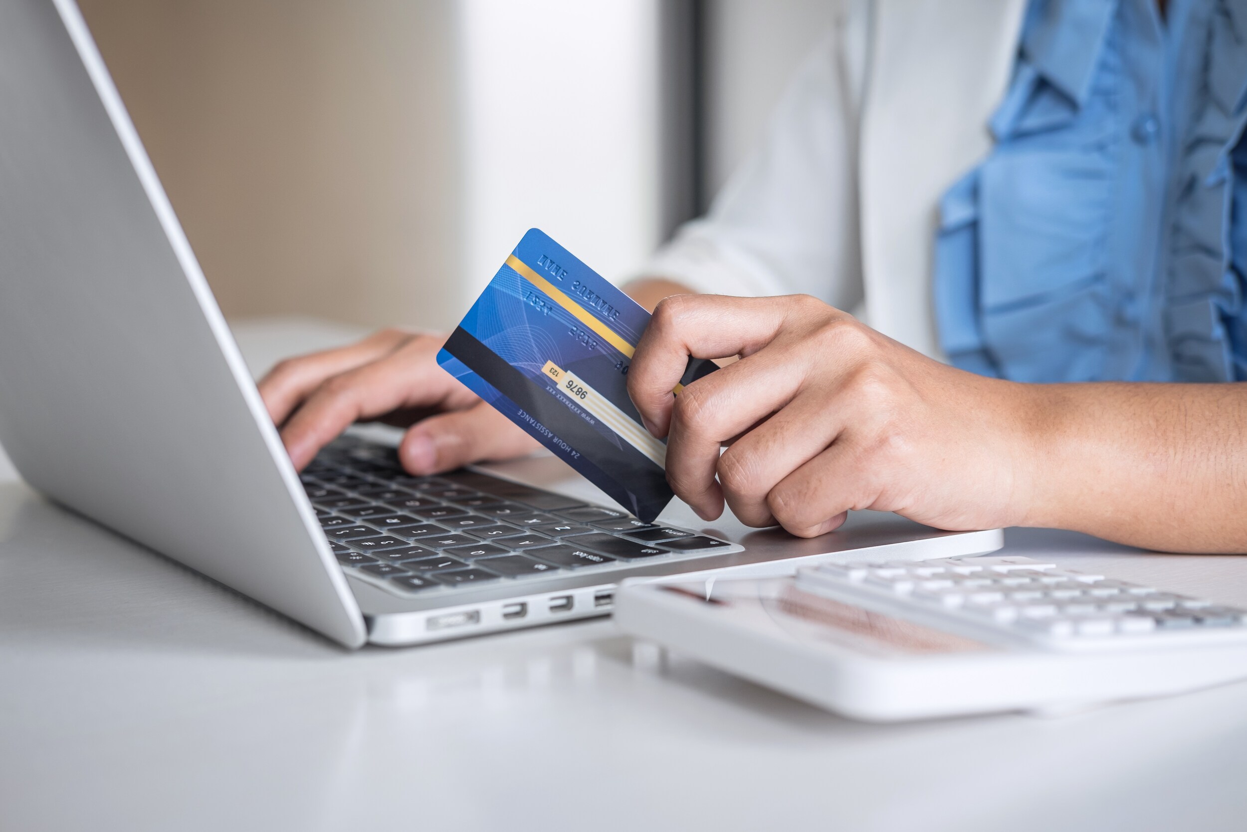 West Broad Kia is a Kia Dealership in Richmond near Laurel, VA | Closeup of online shopper holding credit card
