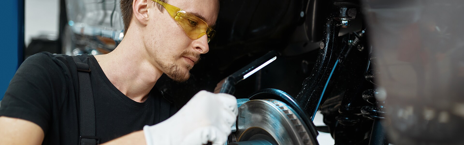 Brake replacement and Safety at West Broad Kia of Richmond | Mechanic working on brake rotor