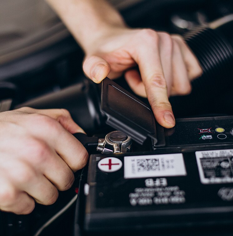 How to Jump Start a Car | West Broad Kia in Henrico, VA | Person opening lid to car battery