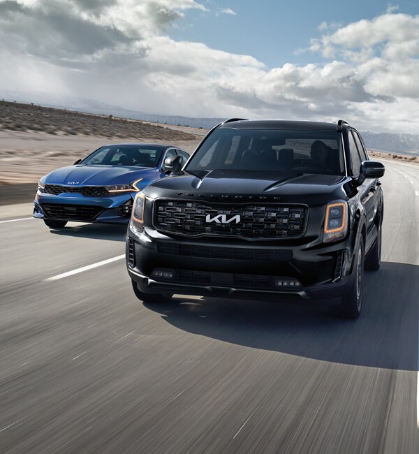 Basic Car Maintenance and Servicing Checklist | West Broad Kia | A 2022 Kia Telluride Driving Down a Desert Road with a 2022 K5 Next to and Slightly Behind it