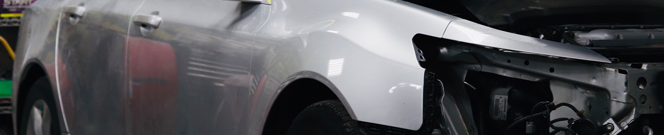 What is Paintless Dent Repair? | West Broad VW | Silver car in the body shop with headlights missing