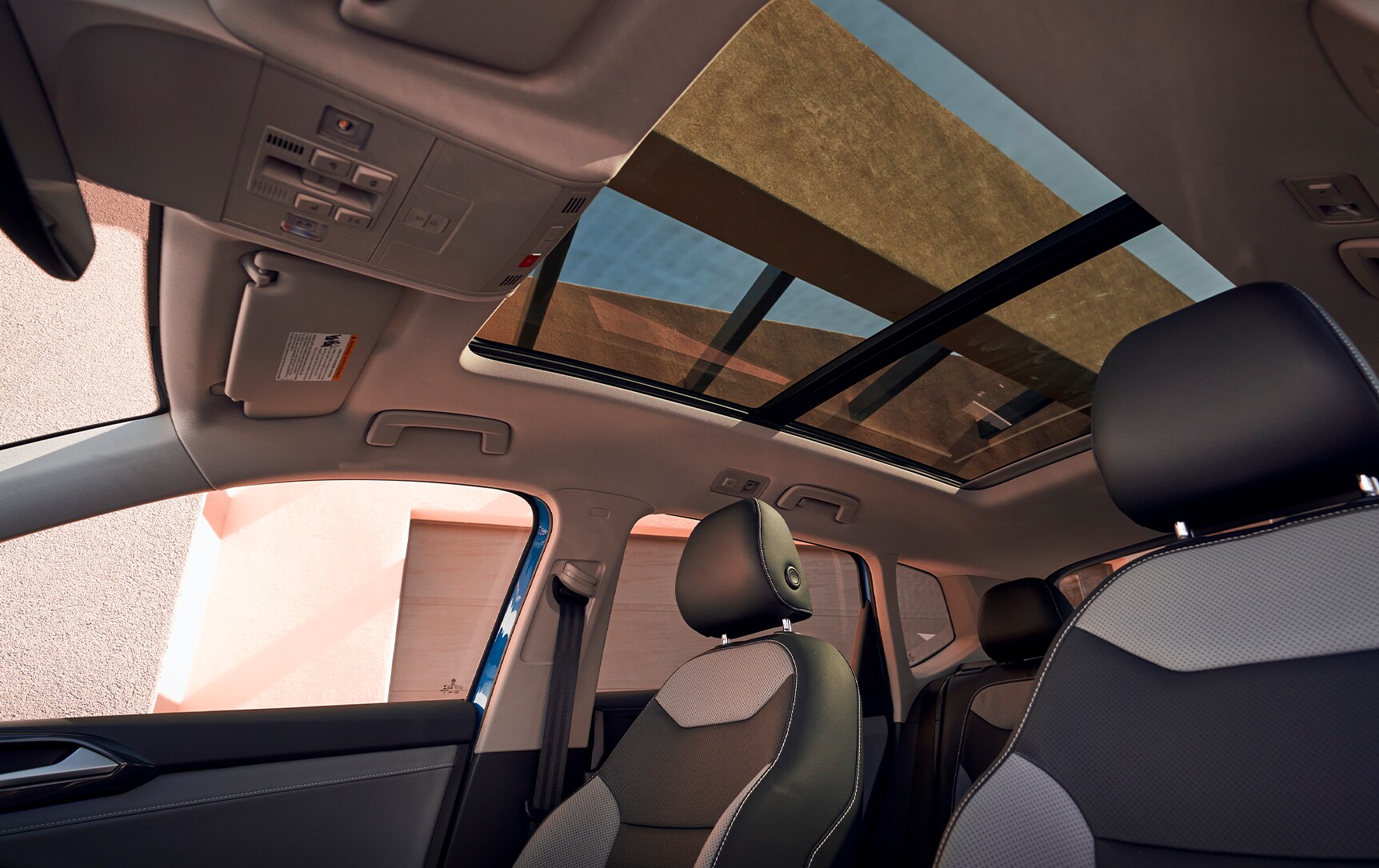 Model Features of the 2023 Volkswagen Taos at West Broad VW | Interior of a Volkswagen Taos showing the panoramic sunroof and leather seats