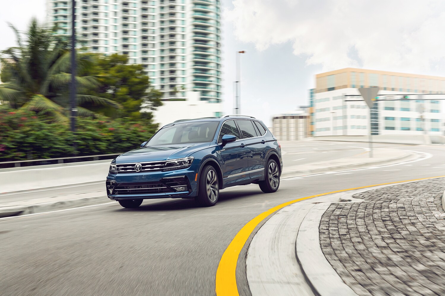 West Broad Volkswagen is a Volkswagen Dealership near Petersburg, VA | 2021 Volkswagen Tiguan driving through city roads