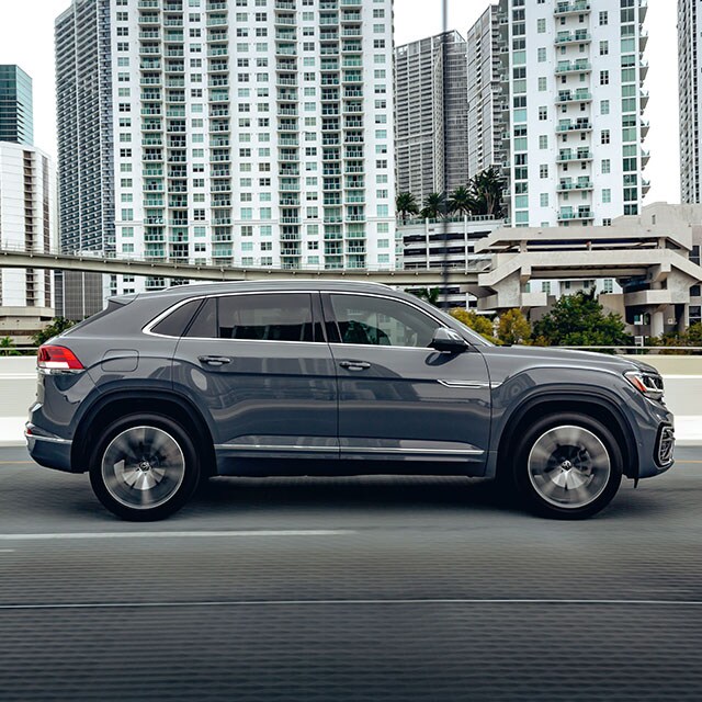 Accessories that help keep your Volkswagen protected at West Broad Volkswagen in Richmond, VA | Profile of Dark Gray Volkswagen Atlas CrossSport Driving through City