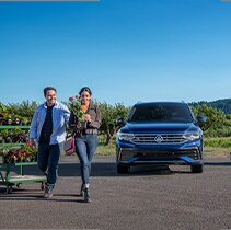 Model Features of the 2021 Volkswagen Tiguan at West Broad VW | Tiguan parked forward facing by flowers