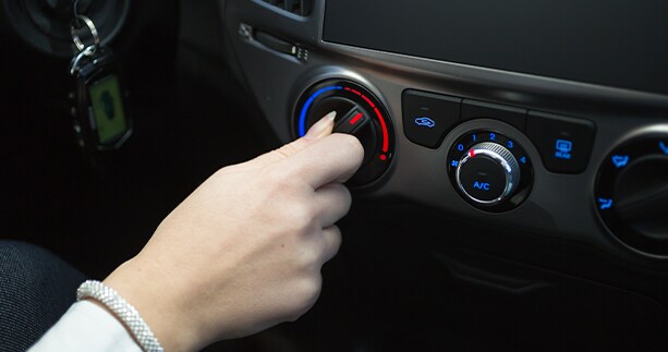 How to prepare your Volkswagen for the winter season in Richmond, VA at West Broad VW | Person's hand turning the tmperature knob to warm