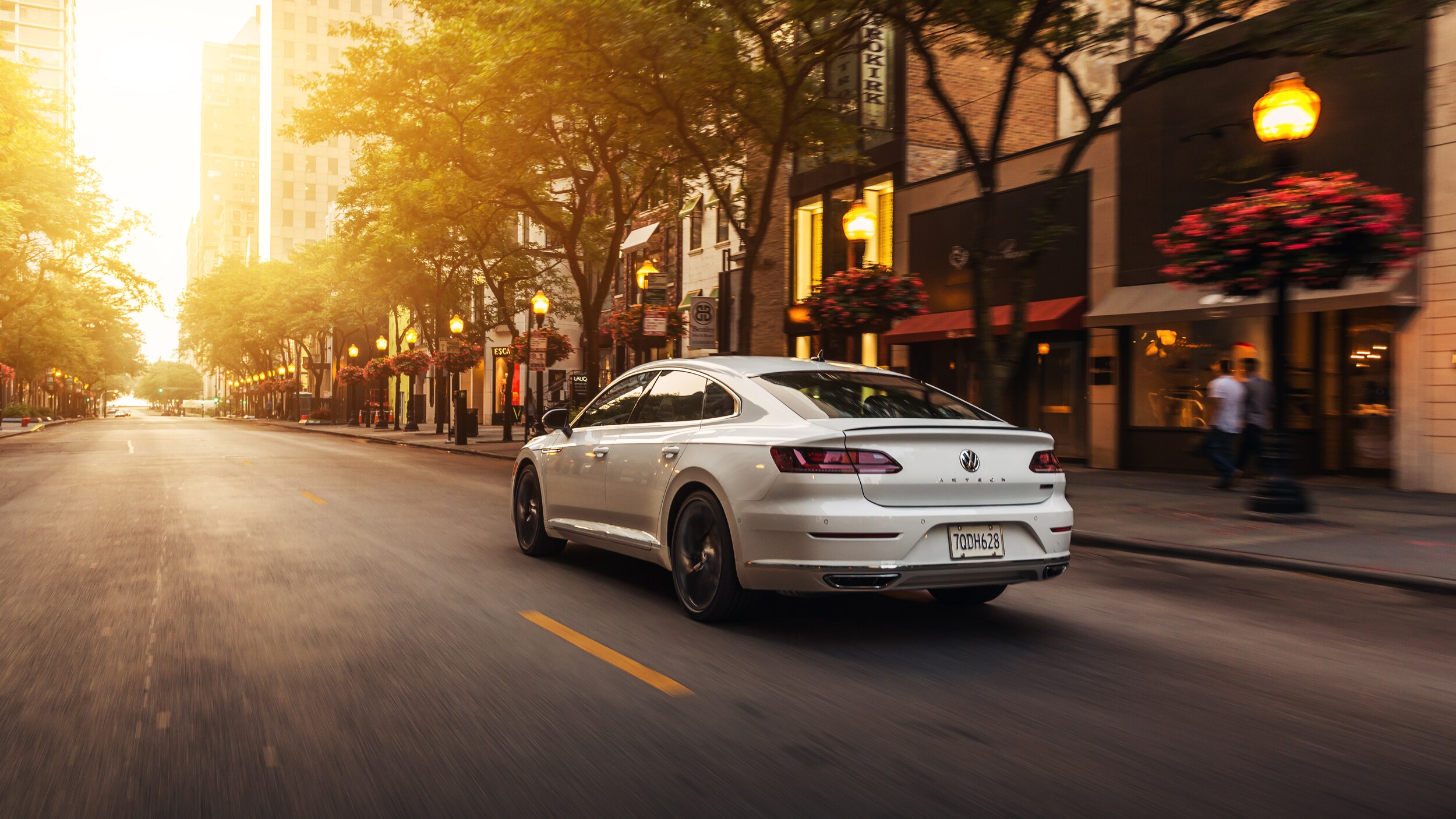 West Broad Volkswagen is a Volkswagen Dealership near Laurel, VA | 2020 Volkswagen Arteon driving on quaint street at sunset
