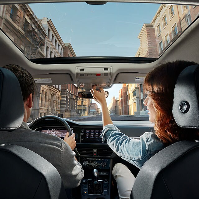 Accessories that help keep your Volkswagen protected at West Broad Volkswagen in Richmond, VA | Interior SHot from Backseat of Volkswagen Jetta with People sitting in Driver and Passenger Seats