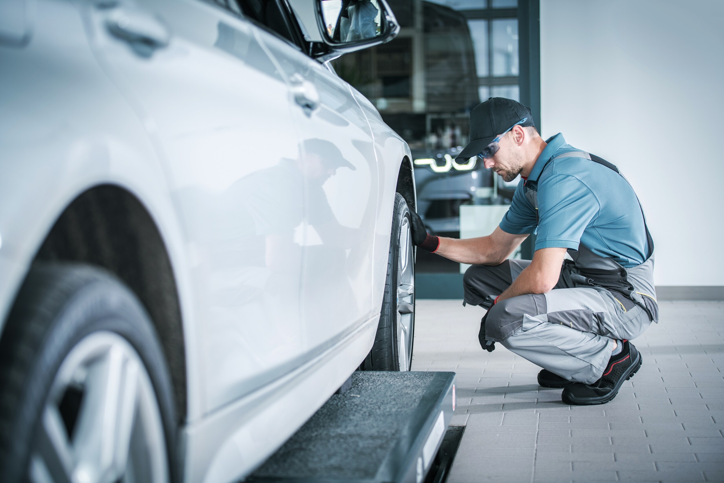 West Broad Volkswagen is a Volkswagen Dealership near Charlottesville, VA | Mechanic changing tire on Volkeswagen vehicle